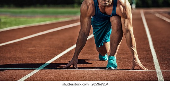 young muscular athlete is at the start of the treadmill - Powered by Shutterstock