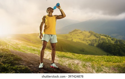 Young Muscular Build Man Drinking Water Of Bottle After Running, 