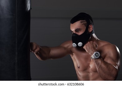 Young Muscular Man Boxing In High Altitude Mask