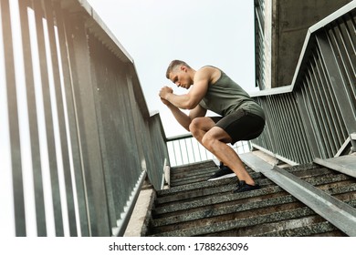 Young and muscular man during workout on a stairscase - Powered by Shutterstock