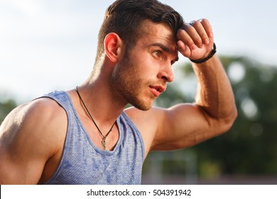 Young Muscular Sweaty Man After Workout Outside On Sunny Day