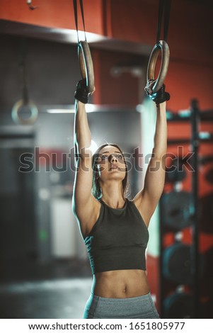 young adult trained woman concentrate at her excercise in gym