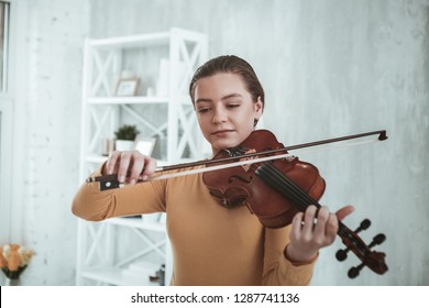 Young Musician. Nice Good Looking Girl Holding A Violin Bow While Preparing To Play