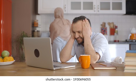 Young Muslim Businessman Working With Computer At Home During The Epidemic. Muslim Businessman Who Made A Very Important Mistake Is Upset. Home Working Concept.