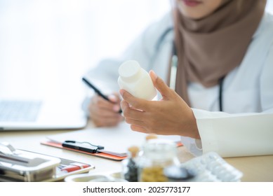 Young Muslim Doctor Explain About Medicine Tablet, Advise Patient, Happy Women Smiling, Close Up Medicine, Health Care Concept At Hospital, Brown Hijab, Asian Girl 