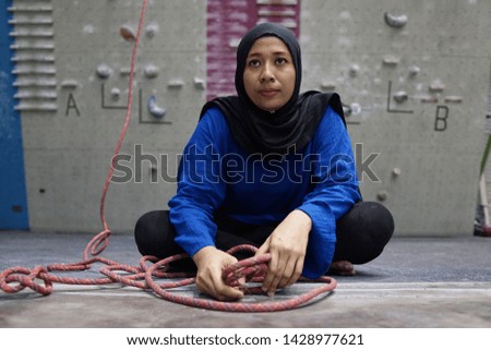 Young muslim female athlete passionate about wall climbing