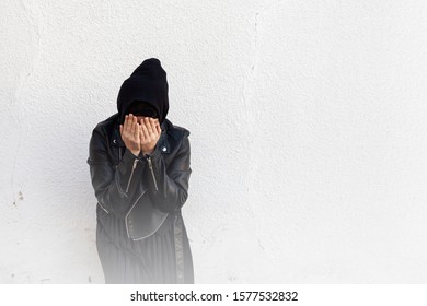 Young Muslim Girl Covering Face With Palms. Victim Of Domestic Violence And Abuse. Arabian Woman Hiding Her Face With Hands And Feeling Ashamed. Tired Female, Trying To Escape Life Problems And Mess