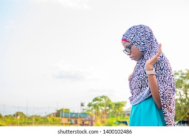 Young Muslim Girl Praying Outside