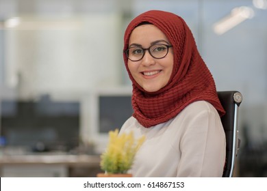 Young muslim hijab business woman in office, portrait