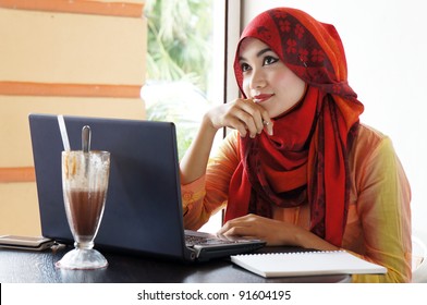Young muslim stylish women thinking on something at a cafe