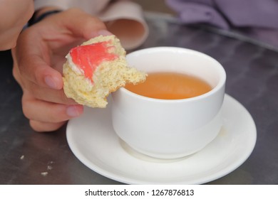 Young Muslim Woman Eating Delicious Scone With Strawberry Jam And Tea At The Strawberry Farm At Cameron Highland.