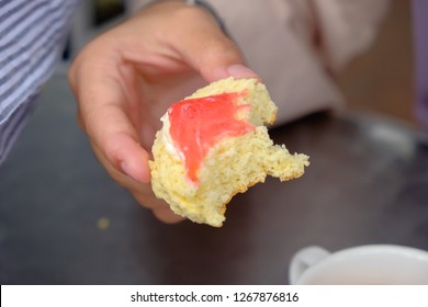 Young Muslim Woman Eating Delicious Scone With Strawberry Jam And Tea At The Strawberry Farm At Cameron Highland.