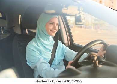 Young Muslim Woman In Modern Car