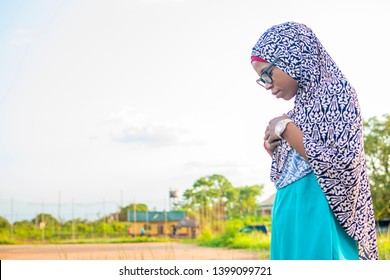 Young Muslim Woman Praying Outside