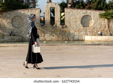 Young Muslim Woman Is Walking In A Modern City	
