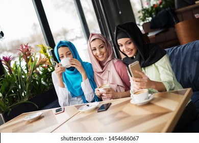young Muslim women are having fun at a coffee shop