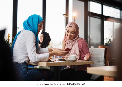 young Muslim women are having fun at a coffee shop - Powered by Shutterstock