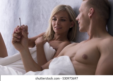 Young Naked Couple Smoking In Bed After One Night Stand