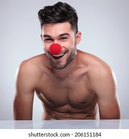 Young Naked Man With Red Clown Nose Laughing For The Camera