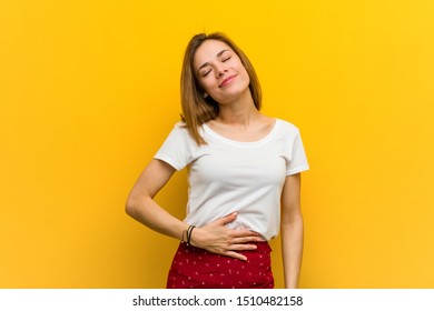 Young natural caucasian woman touches tummy, smiles gently, eating and satisfaction concept. - Shutterstock ID 1510482158