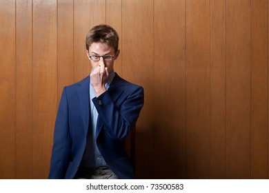 Young nerdy Caucasian man adjusts his eyeglasses - Powered by Shutterstock