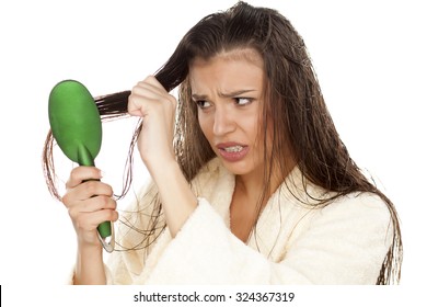 Young Nervous Woman In Bathrobe Brush Her Moist Hair