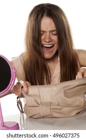 Young Nervous Woman Rummaging In Her Purse