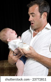 Young New Dad Learning To Take Care Of Cranky Newborn