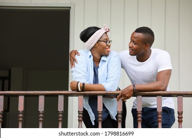 Young Newly Wed African American Couple Leaning On The Balcony At Home With Copy Space