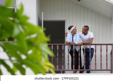 Young Newly Wed African American Couple Leaning On The Balcony At Home With Copy Space