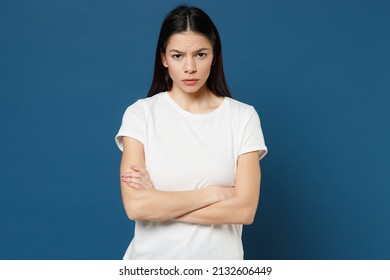 Young Nice Spanish Attractive Confident Serious Strict Beautiful Latin Woman 20s Wearing White Casual Basic T-shirt Holding Hands Crossed Folded Isolated On Dark Blue Color Background Studio Portrait