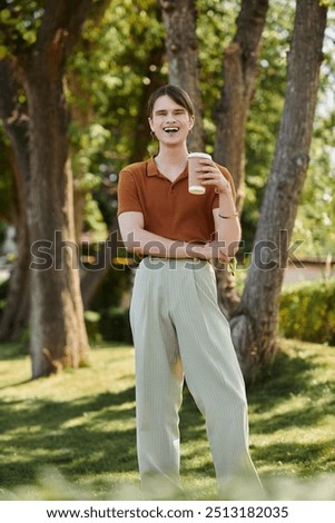 Similar – Image, Stock Photo Young non-binary person drinking juice standing in the doorway of a cafe
