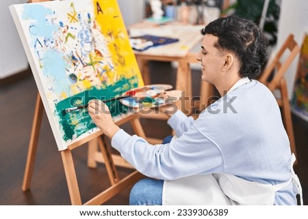 Young non binary man artist smiling confident drawing at art studio