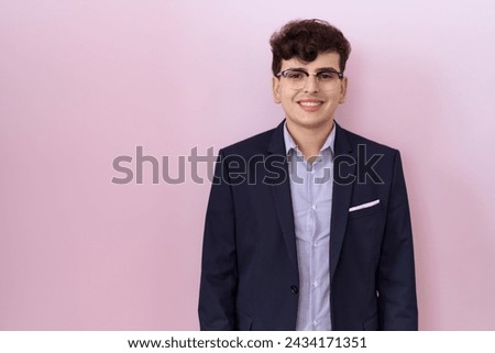 Young non binary man with beard wearing suit and tie with a happy and cool smile on face. lucky person. 