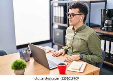 Young non binary man business worker meditating at office - Powered by Shutterstock