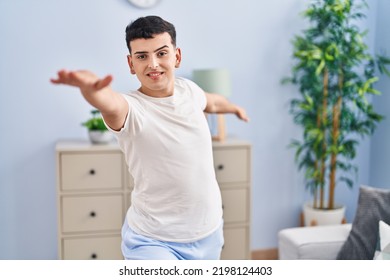 Young non binary man doing yoga exercise sitting on floor at home - Powered by Shutterstock