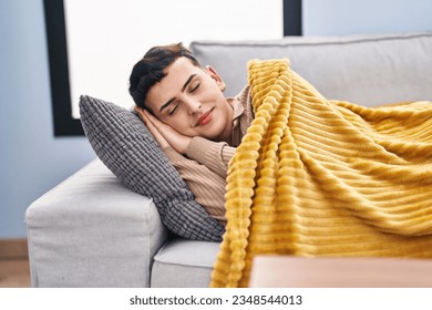 Young non binary man lying on sofa sleeping at home
