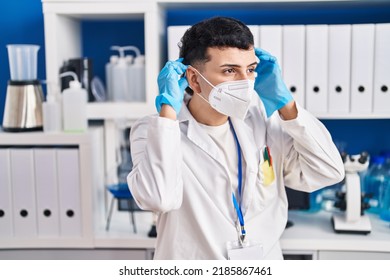 Young Non Binary Man Scientist Wearing Medical Mask At Laboratory