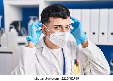 Young Non Binary Man Scientist Wearing Medical Mask At Laboratory