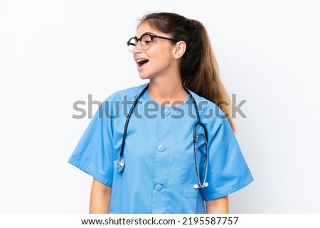 Young nurse doctor woman isolated on white background laughing in lateral position