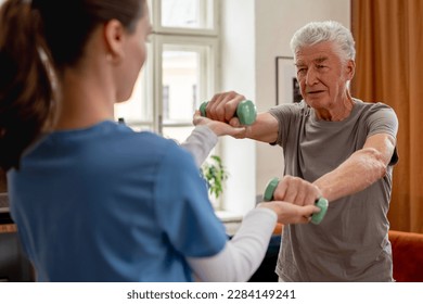 Young nurse doing exercise with senior man. - Powered by Shutterstock