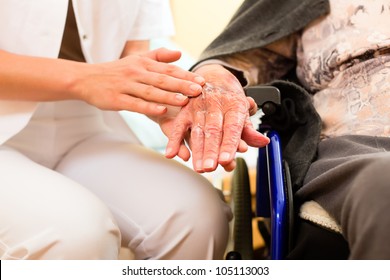 Young nurse and female senior in nursing home, the old lady sitting in a wheel chair - Shutterstock ID 105113003