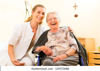 Young nurse and female senior in nursing home, the old lady sitting in a wheel chair - Shutterstock ID 129373688