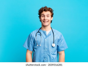 Young Nurse Man Looking Happy And Pleasantly Surprised, Excited With A Fascinated And Shocked Expression