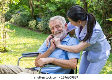 Young Nurse Take Care Senior Man At Home, Senior Man Happniess And Smiling With Nurse, Health Care Concept