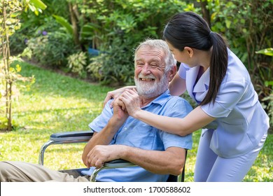 Young Nurse Take Care Senior Man At Home, Senior Man Happniess And Smiling With Nurse, Health Care Concept