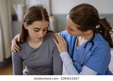 Young nurse taking care of teenage girl, consoling her. - Powered by Shutterstock