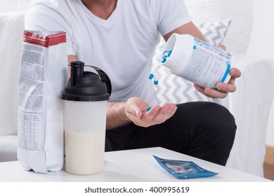 Young Obsessed Man Taking Medicine For Muscles