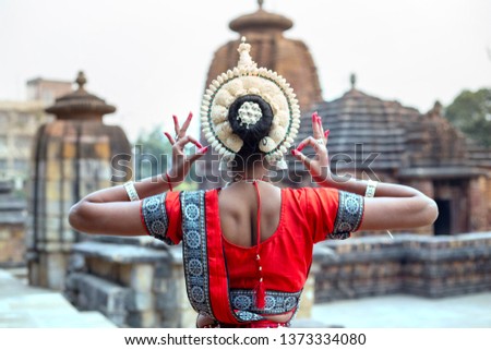 Young odissi female artist shows her inner beauty at Mukteshvara Temple,Bhubaneswar, Odisha, India