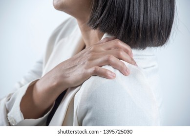 Young office woman hand Squeeze on the shoulder.Shoulder pain concept Office Syndrome - Shutterstock ID 1395725030